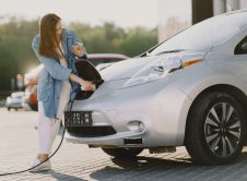 Woman Charging Electro Car At The Electric Gas Station Scaled