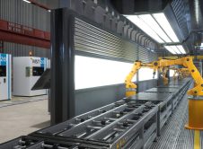Robot Arms Working On Assembly Line In Factory Next To Computerized Machines Original 2418056