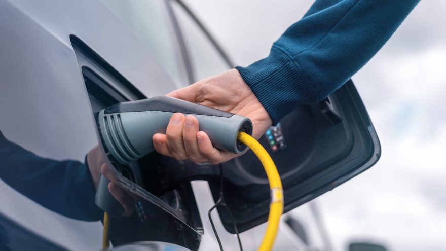 Man Charging Electric Car