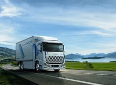 White,truck,driving,on,the,asphalt,road,next,to,the